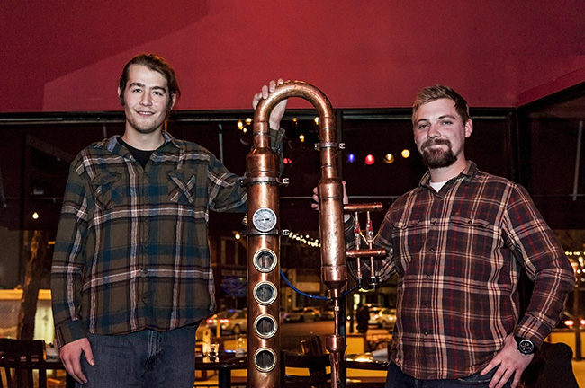 Simeon and Mark showing off their copper still at a Minnesota Distillers Guild meeting